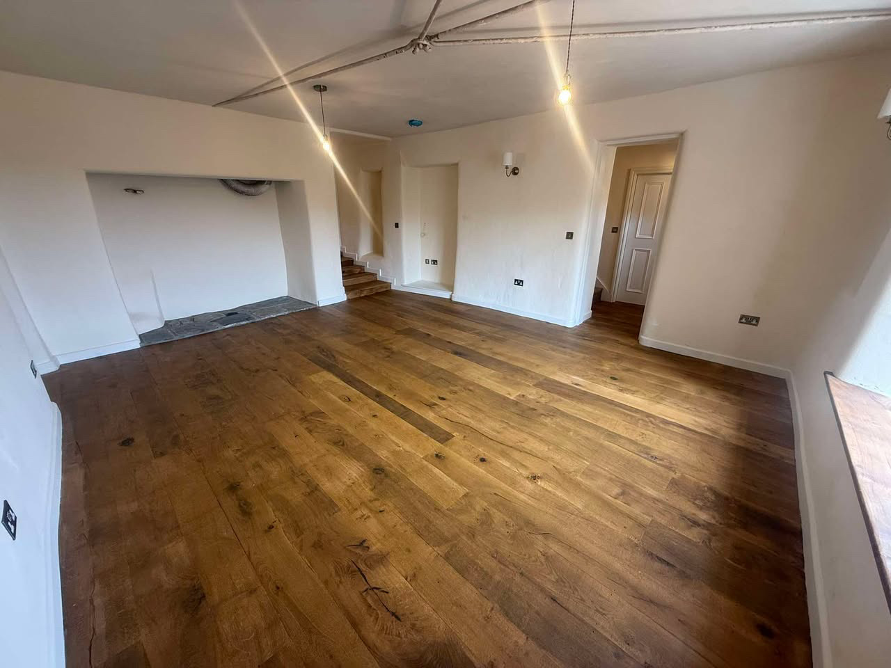 Renovated room with new solid oak floorboards and lime plastered walls